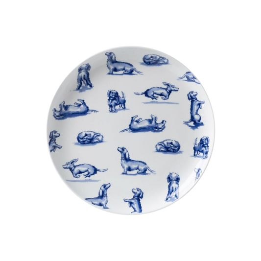 Ein weißer Frühstücksteller mit blauem Aufdruck von verschiedenen Hunde- und Hasenmotiven in verspielten Posen, umrandet von einem gestreiften blauen Rand.