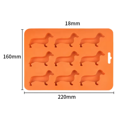 Orangefarbene Silikonform mit neun Dackel-Förmchen, geeignet für Schokolade, Plätzchen oder Eiswürfel.