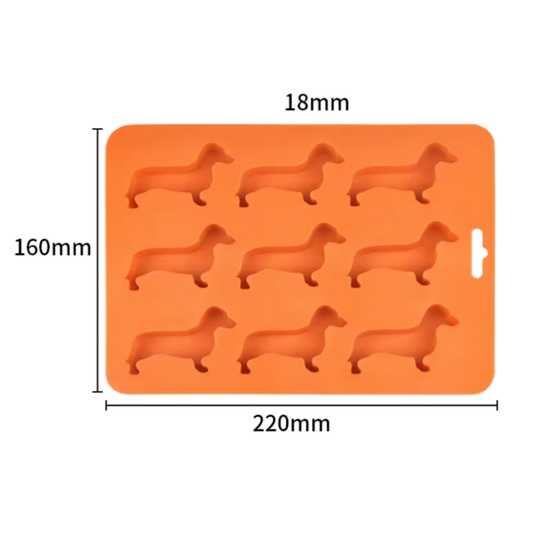 Orangefarbene Silikonform mit neun Dackel-Förmchen, geeignet für Schokolade, Plätzchen oder Eiswürfel.