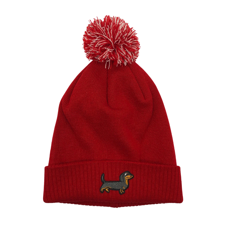 Strickmütze mit Bommel und gesticktem Dackelmotiv auf dem Umschlag, erhältlich in neun verschiedenen Farben.