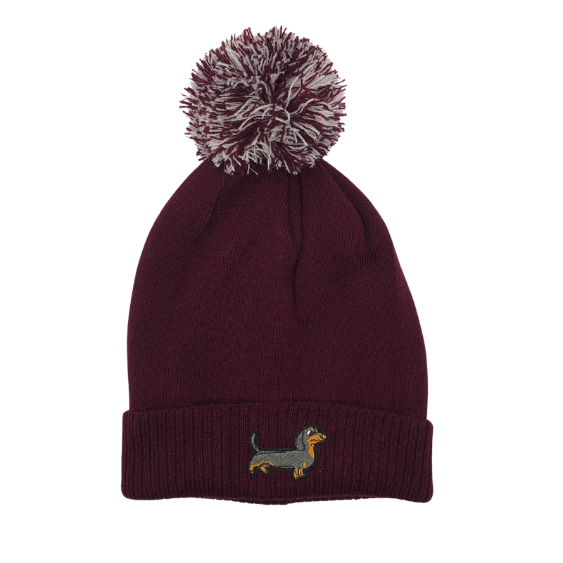 Strickmütze mit Bommel und gesticktem Dackelmotiv auf dem Umschlag, erhältlich in neun verschiedenen Farben.