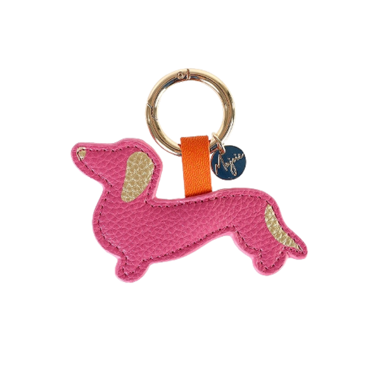 Schlüsselanhänger in Dackelform aus pinkfarbenem Leder mit goldenen Details an Ohr und Rute, befestigt an einem goldenen Schlüsselring mit orangener Schlaufe und rundem Anhänger.
